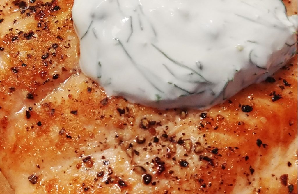 pan-seared salmon with a dollop of creamy dill sauce
